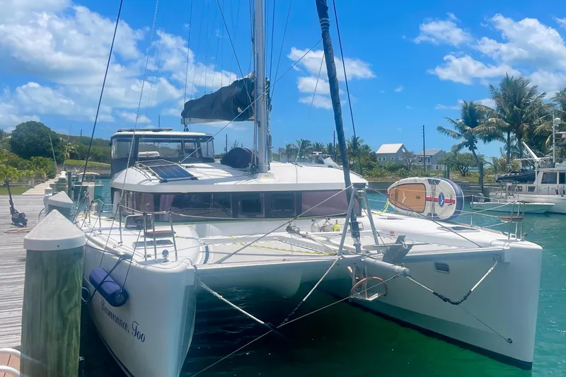The Image of 2016 Lagoon 450 S catamaran docked in a sunny marina setting. - 0
