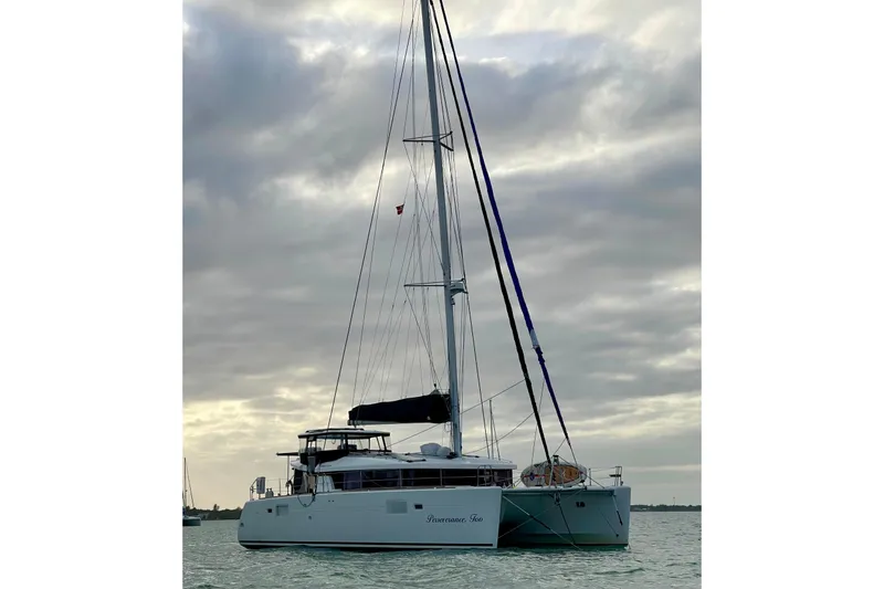 The Image of 2016 Lagoon 450 S catamaran sailing on calm waters under cloudy skies. - 1