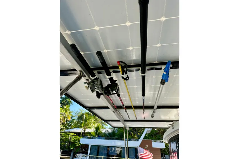 Slide: The Image of Fishing rods stored on a 2016 Lagoon 450 S catamaran, with a scenic background. - 101