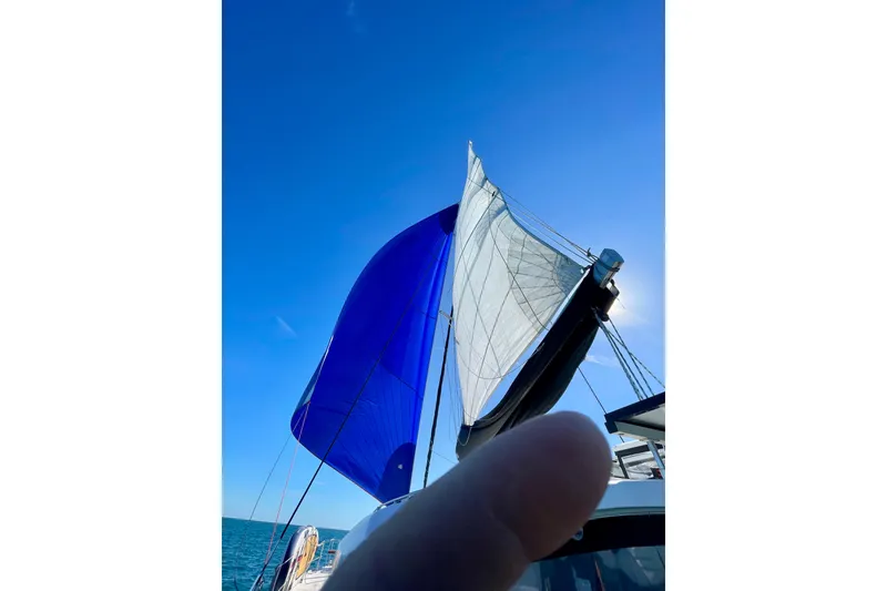 Slide: The Image of Sailing on a 2016 Lagoon 450 S catamaran with vibrant blue and white sails. - 12