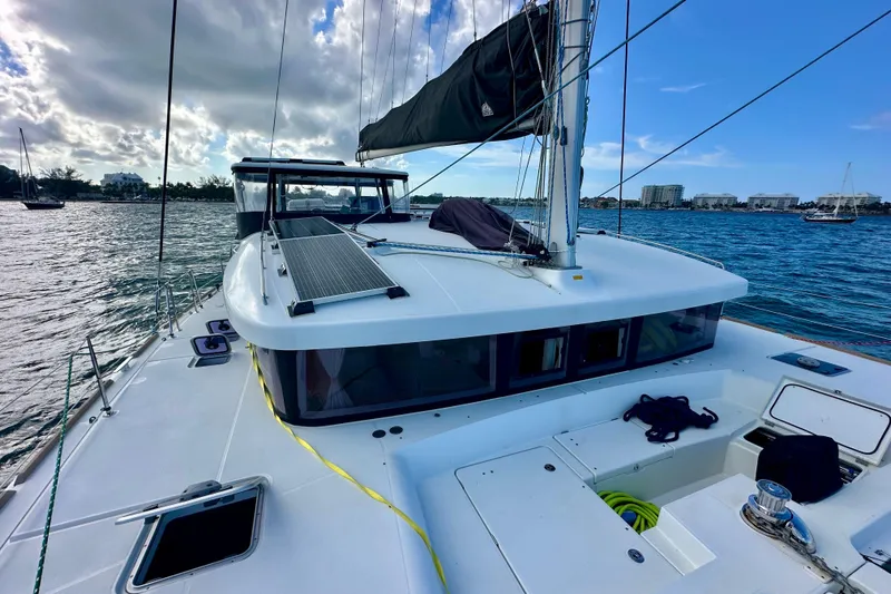 Slide: The Image of 2016 Lagoon 450 S catamaran on water, featuring sleek design and solar panels. - 17