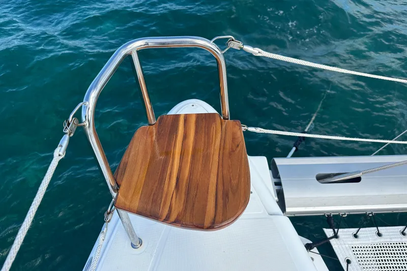 Slide: The Image of Wooden seat on 2016 Lagoon 450 S yacht, overlooking blue ocean water. - 18