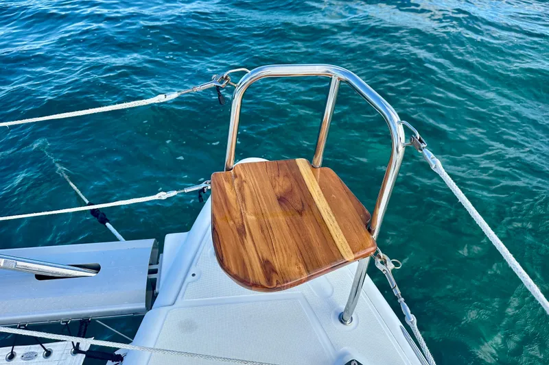 Slide: The Image of Lagoon 450 S (2016) yacht with wooden seat and stainless steel railing over blue water. - 19