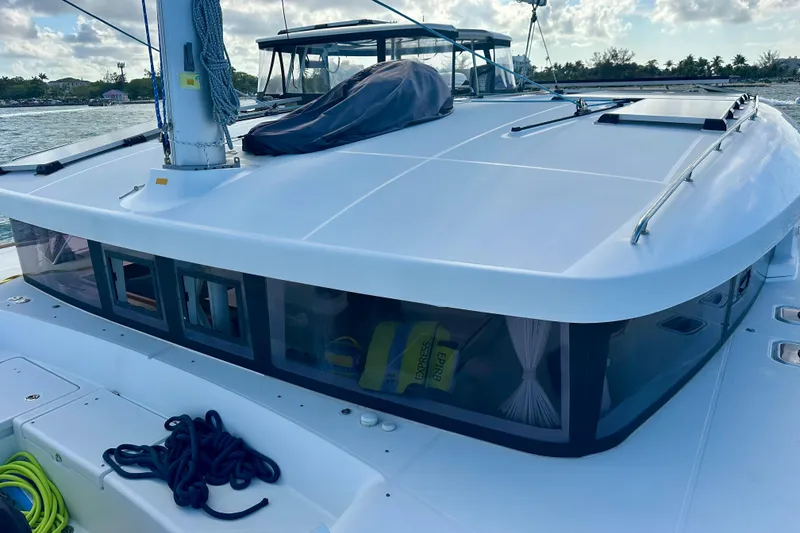 Slide: The Image of 2016 Lagoon 450 S catamaran deck with ropes and scenic waterfront view. - 20