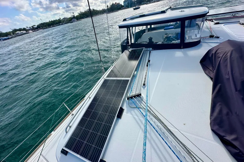 Slide: The Image of Lagoon 450 S 2016 catamaran with solar panels on deck, sailing in open water. - 23