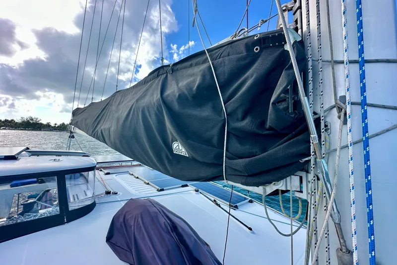 Slide: The Image of Lagoon 450 S 2016 sailboat with covered mainsail, docked under a partly cloudy sky. - 25