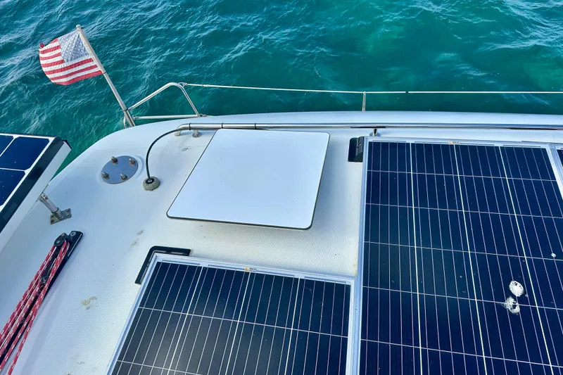 Slide: The Image of Solar panels on 2016 Lagoon 450 S yacht deck with American flag, ocean background. - 26