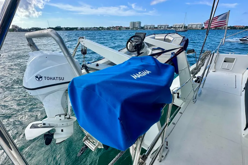 Slide: The Image of Lagoon 450 S catamaran with Tohatsu engine and Magma grill, sailing in coastal waters. - 28