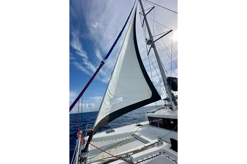 Slide: The Image of Sailing on a 2016 Lagoon 450 S catamaran with white sails against a blue sky. - 42