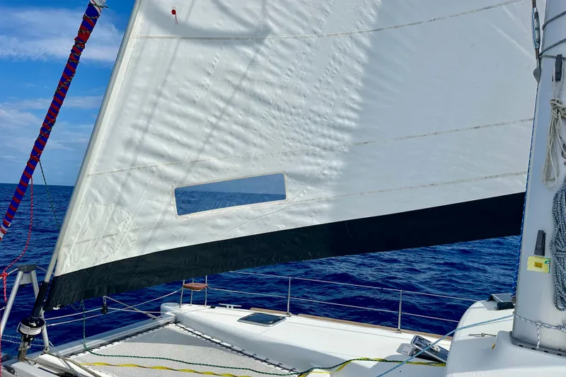 Slide: The Image of Sailing on a 2016 Lagoon 450 S catamaran with white sails against a blue ocean backdrop. - 44