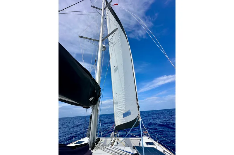 Slide: The Image of Sailing on a 2016 Lagoon 450 S catamaran under clear blue skies. - 48