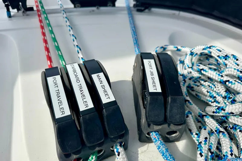 Slide: The Image of Sailing controls on a 2016 Lagoon 450 S catamaran, featuring labeled ropes and cleats. - 51