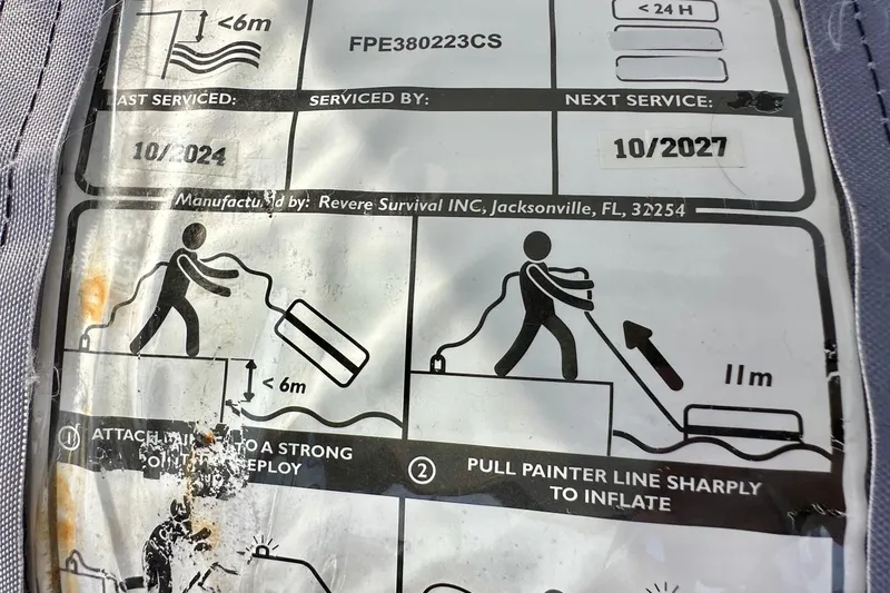 Slide: The Image of Instruction label for life raft deployment, manufactured by Revere Survival INC, Jacksonville, FL. - 55