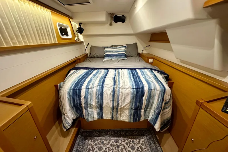 Slide: The Image of Cozy cabin interior of 2016 Lagoon 450 S yacht with striped bedding. - 60