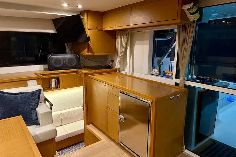 Slide: The Image of Interior of 2016 Lagoon 450 S yacht with modern wood cabinetry and seating area. - 78