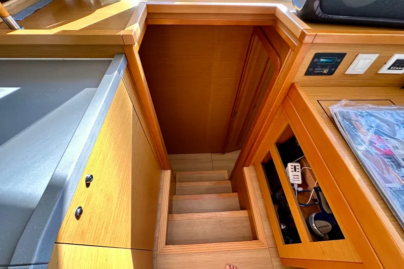 Slide: The Image of Interior view of 2016 Lagoon 450 S yacht, featuring wooden stairs and cabinetry. - 79