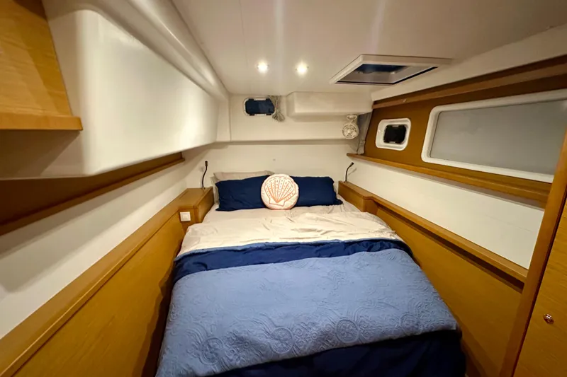 Slide: The Image of Cozy bedroom interior of 2016 Lagoon 450 S yacht with blue bedding and wooden accents. - 80