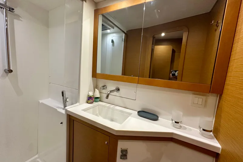 Slide: The Image of Modern bathroom interior on a 2016 Lagoon 450 S yacht, featuring a sleek sink and mirror. - 88