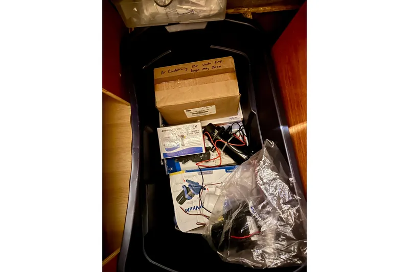 Slide: The Image of Box of assorted boat parts and accessories inside a Lagoon 450 S, 2016 model. - 90