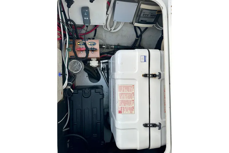 Slide: The Image of Engine compartment of a 2016 Lagoon 450 S catamaran, featuring wiring and equipment. - 94