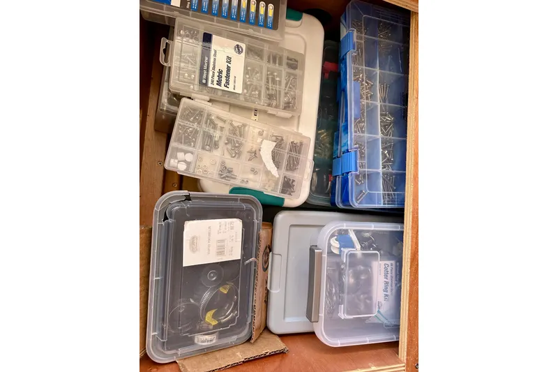 Slide: The Image of Assorted fasteners and tools organized in plastic containers on a Lagoon 450 S, 2016 model. - 99