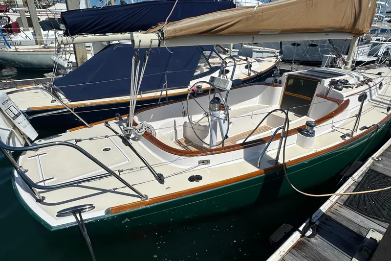 Slide: The Image of 2011 Alerion Sport 33 sailboat docked, featuring sleek design and polished wood accents. - 10