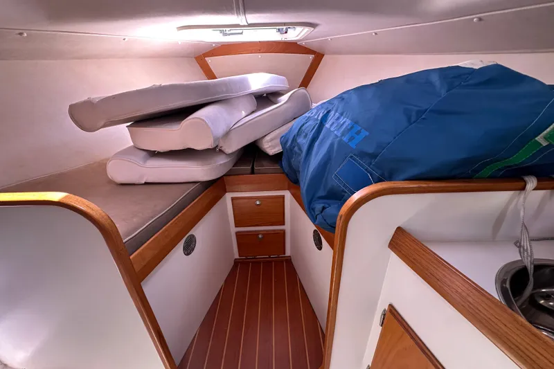 Slide: The Image of Interior cabin of 2011 Alerion Sport 33 sailboat with cushions and sail storage. - 16