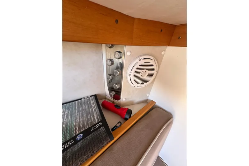 Slide: The Image of Interior of 2011 Alerion Sport 33 showing speaker, flashlight, and wooden trim. - 17