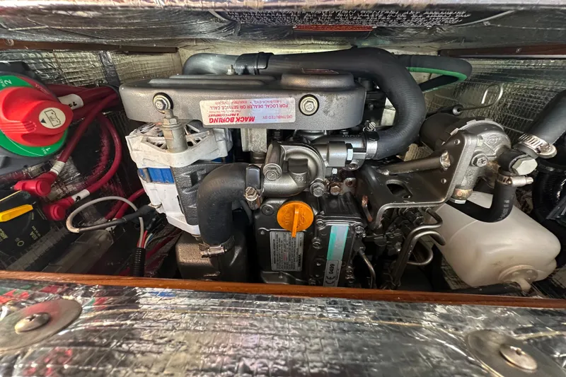 Slide: The Image of Engine compartment of a 2011 Alerion Sport 33 sailboat, showcasing mechanical components. - 19