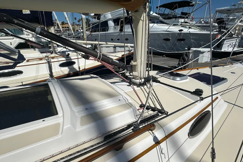 Slide: The Image of Sailboat deck of 2011 Alerion Sport 33, featuring rigging and hatches at marina. - 2