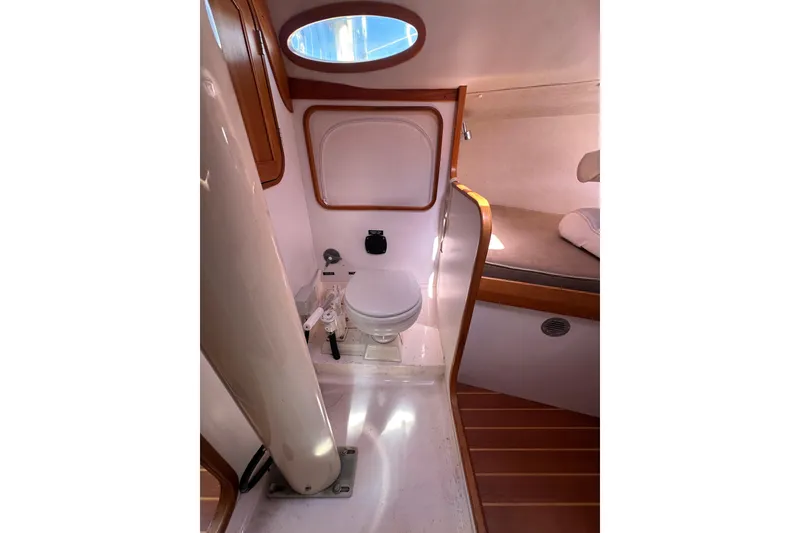 Slide: The Image of Interior of 2011 Alerion Sport 33 sailboat, featuring compact bathroom with toilet and wooden accents. - 20