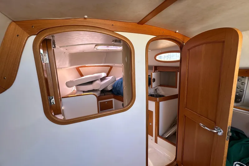 Slide: The Image of Interior of 2011 Alerion Sport 33 sailboat with wooden cabinetry and compact living space. - 22