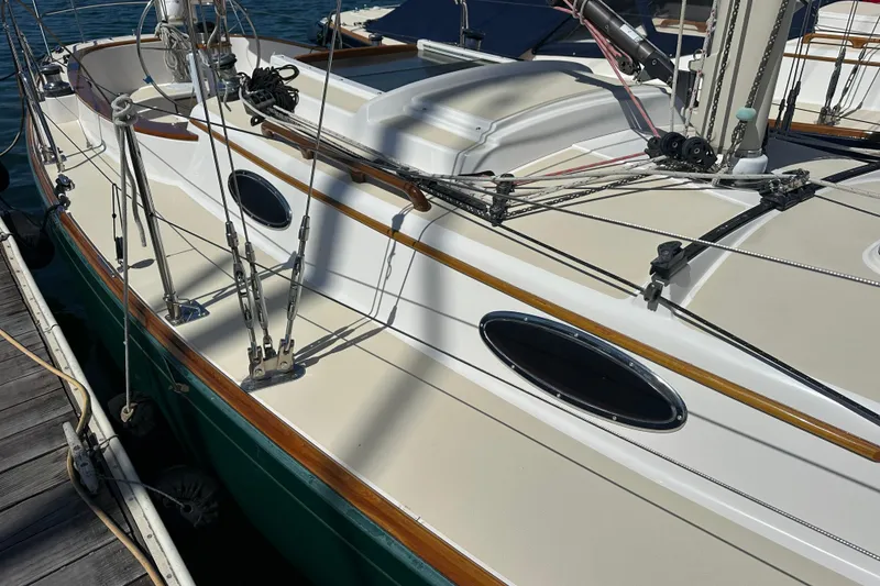Slide: The Image of 2011 Alerion Sport 33 sailboat docked, showcasing deck and rigging details. - 4