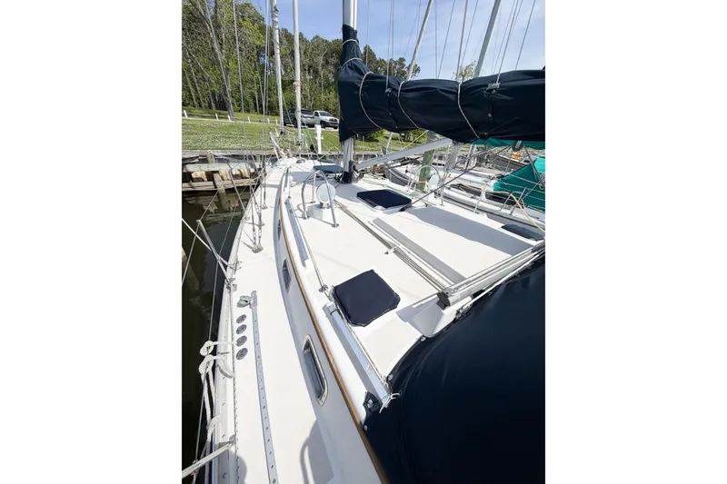 Slide: The Image of 2001 Caliber 40LRC sailboat docked, featuring a clean deck and rigging. - 10