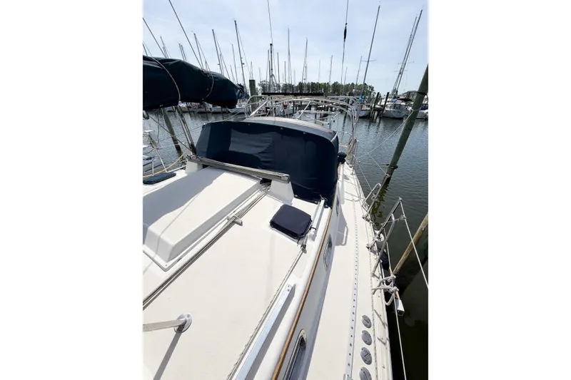 Slide: The Image of 2001 Caliber 40LRC sailboat docked at marina, featuring sleek deck design and covered cockpit. - 11