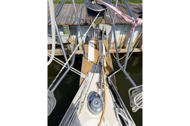 Slide: The Image of Bow view of 2001 Caliber 40LRC sailboat docked, featuring ropes and deck equipment. - 12