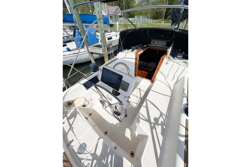 Slide: The Image of Cockpit of 2001 Caliber 40LRC sailboat with navigation equipment and open cabin entrance. - 15