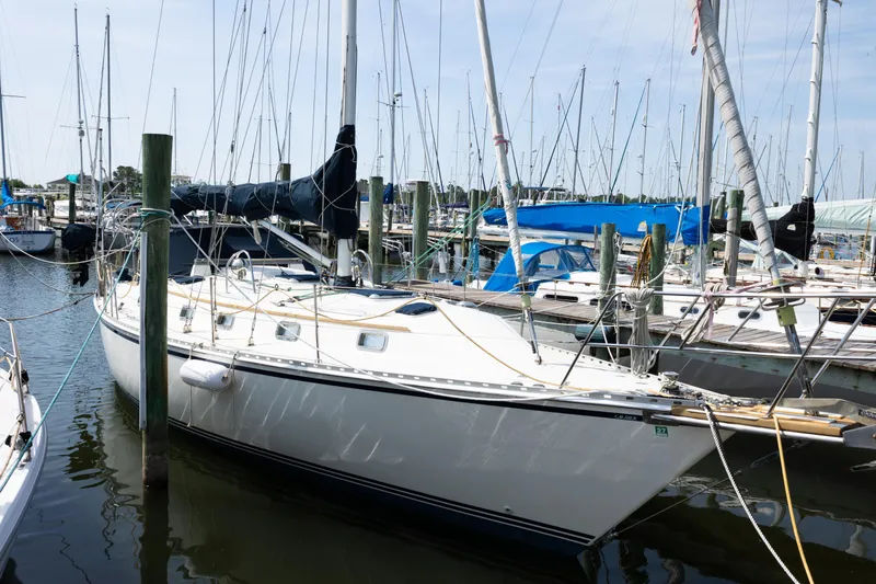 Slide: The Image of Sailboat docked in marina, Caliber 40LRC, 2001 model, surrounded by other boats. - 2