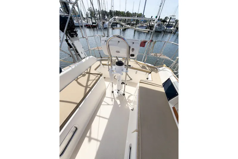 Slide: The Image of Cockpit of 2001 Caliber 40LRC sailboat, featuring steering wheel and seating, docked at marina. - 23