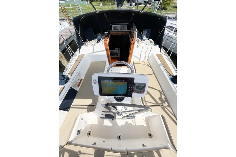 Slide: The Image of 2001 Caliber 40LRC sailboat cockpit with navigation equipment and seating. - 27
