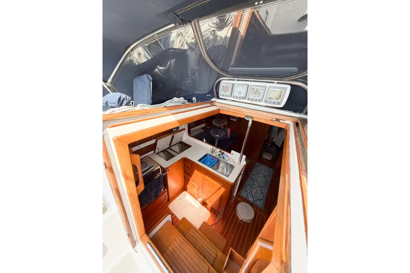 Slide: The Image of Interior view of 2001 Caliber 40LRC sailboat, featuring a compact kitchen and navigation instruments. - 30