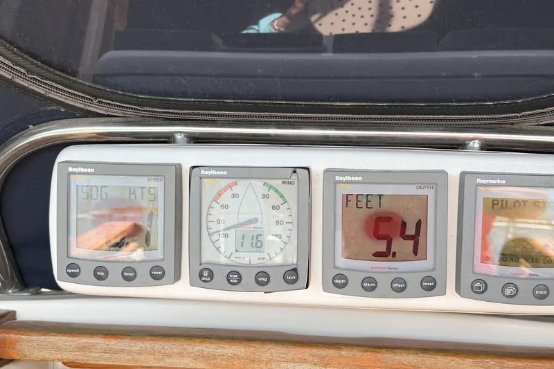 Slide: The Image of Boat instrument panel displaying speed, wind, and depth readings on a 2001 Caliber 40LRC. - 31