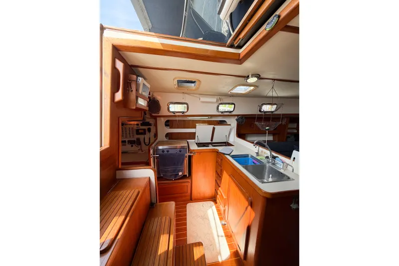 Slide: The Image of Interior of 2001 Caliber 40LRC sailboat with wooden cabinetry and kitchen area. - 32