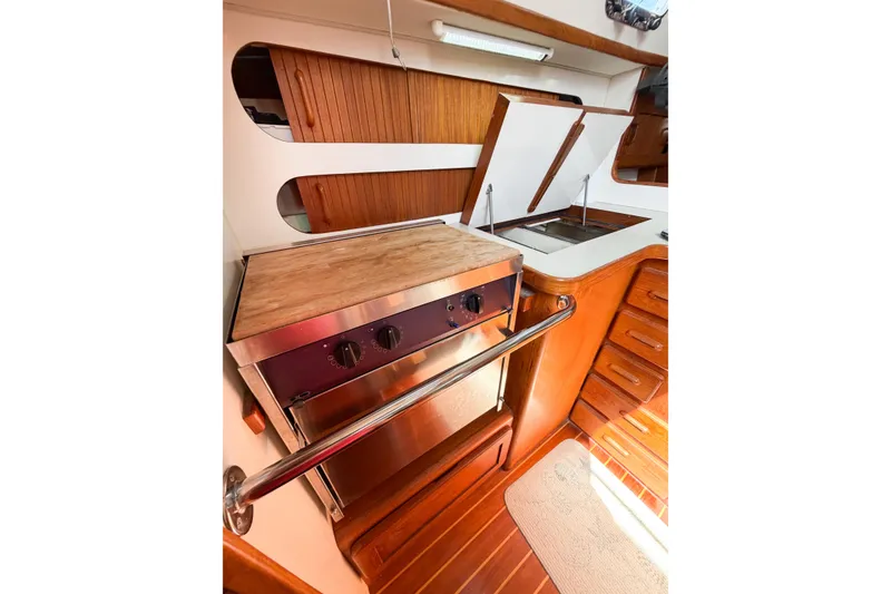 Slide: The Image of 2001 Caliber 40LRC yacht kitchen with wooden cabinetry, stove, and sink. - 38