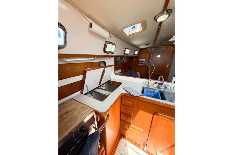 Slide: The Image of Interior of 2001 Caliber 40LRC sailboat featuring kitchen area with wooden cabinetry. - 39
