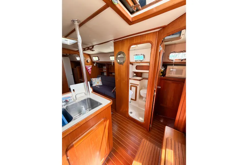 Slide: The Image of Interior of 2001 Caliber 40LRC yacht with wooden finishes and compact amenities. - 41