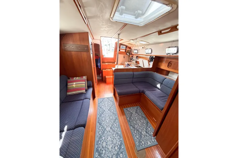 Slide: The Image of Interior of 2001 Caliber 40LRC sailboat with cozy seating and wooden finishes. - 43