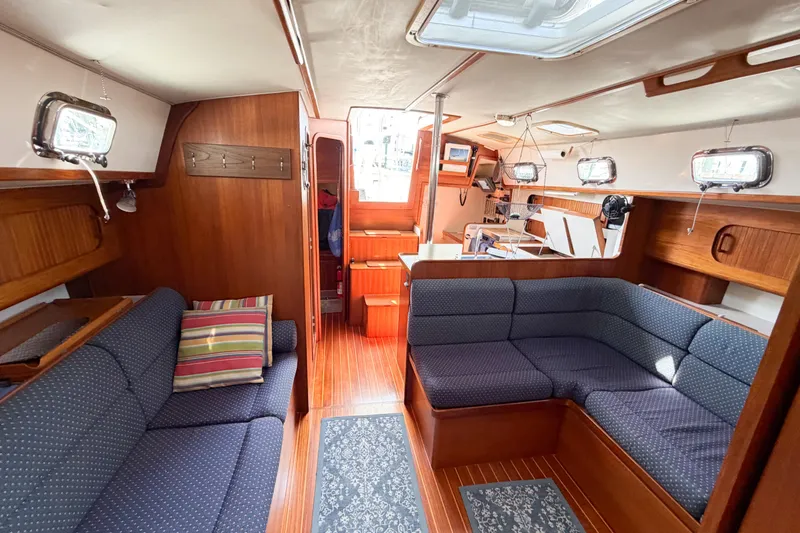 Slide: The Image of Interior of 2001 Caliber 40LRC sailboat with cozy seating and wooden finishes. - 44