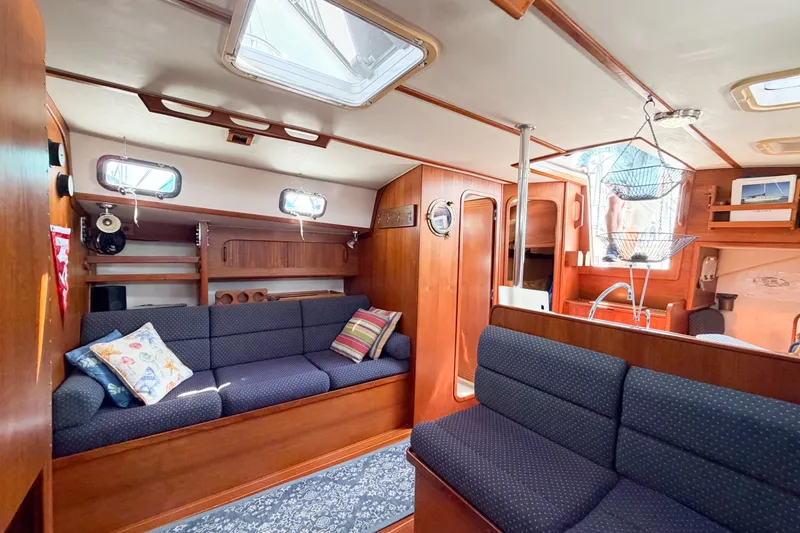 Slide: The Image of Interior of 2001 Caliber 40LRC sailboat with cozy seating and wooden finishes. - 45