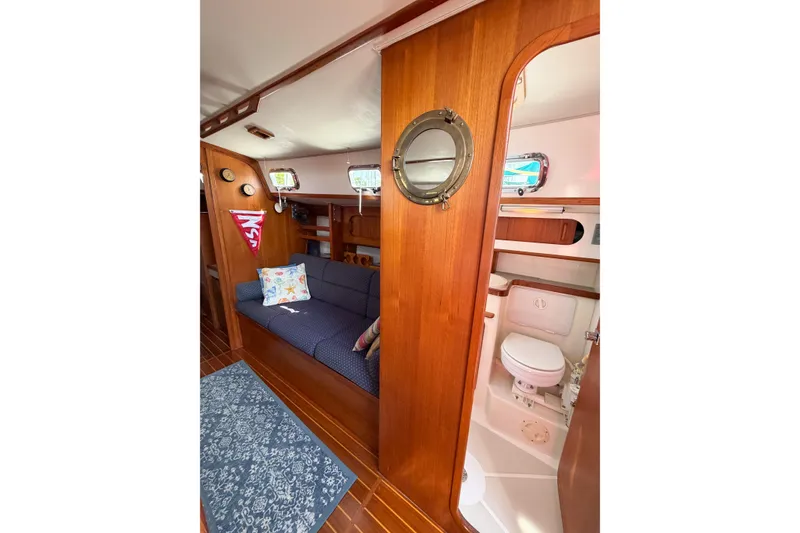 Slide: The Image of Interior of 2001 Caliber 40LRC yacht with cozy seating and compact bathroom. - 46